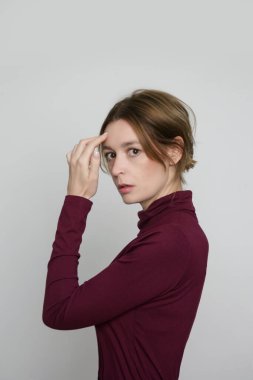 Serie of studio photos of young female model wearing beige turtleneck made from organic cotton. Comfortable sustainable fashion