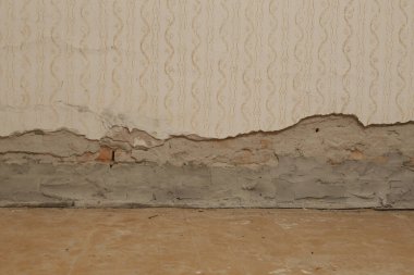 Moisture damage on the wall in the old house and the newly installed insulation of polyethylene barriers against moisture and rising damp. Renovation and home improvement.