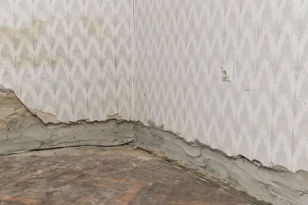 Moisture damage on the wall in the old house and the newly installed insulation of polyethylene barriers against moisture and rising damp. Renovation and home improvement.