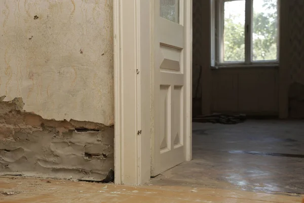 Moisture damage on the wall in the old house and the newly installed insulation of polyethylene barriers against moisture and rising damp. Renovation and home improvement.