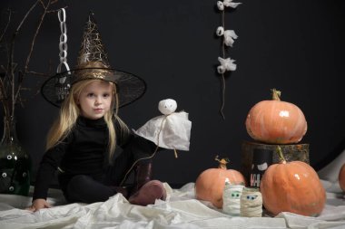 Halloween studio portrait of cute 4 years old girl.