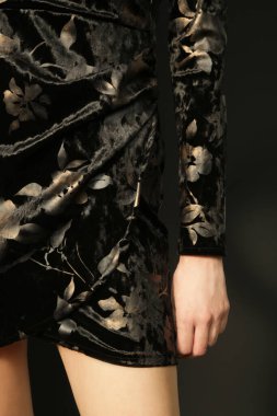 Serie of studio photos of young female model in black textured velvet  dress, autumn fashion collection.