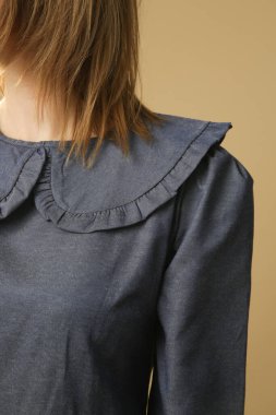 Serie of studio photos of young female model in cotton denim peter pan collar dress
