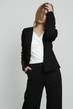 Gündelik iş kıyafeti giymiş genç bir modelin seri fotoğrafları..