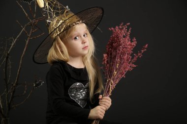Halloween studio portrait of cute 4 years old girl.