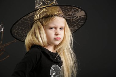 Halloween studio portrait of cute 4 years old girl.