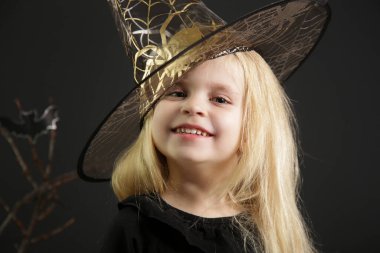 Halloween studio portrait of cute 4 years old girl.