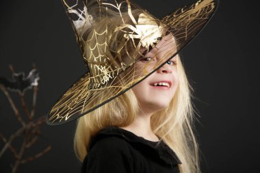 Halloween studio portrait of cute 4 years old girl.