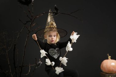 Halloween studio portrait of cute 4 years old girl.