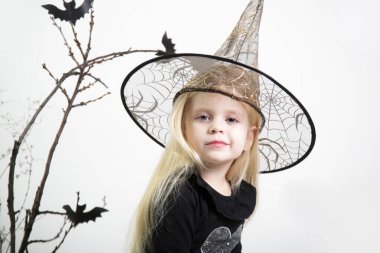 Halloween studio portrait of cute 4 years old girl.