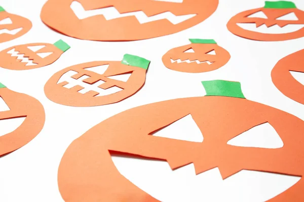 Halloween concept. Paper pumpkins on white background.