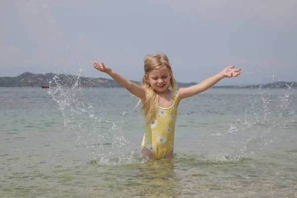 Adorable Toddler Girl Yellow Swimsuit Splashing Water Beach Idyllic Summer — 图库照片