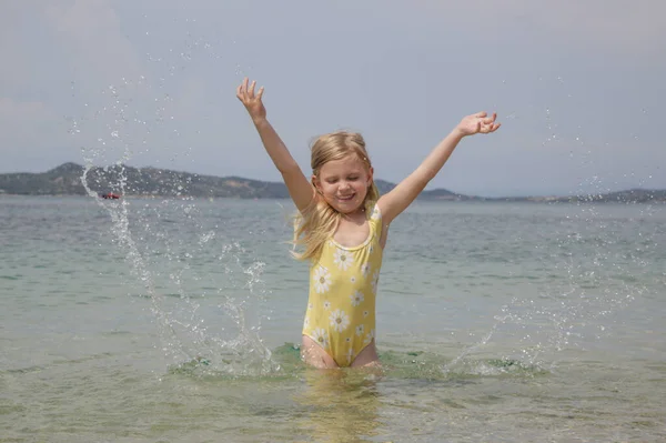 Adorable Toddler Girl Yellow Swimsuit Splashing Water Beach Idyllic Summer — Foto Stock