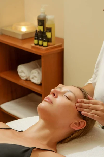 Face massage, a woman in the spa having anti-age face massage