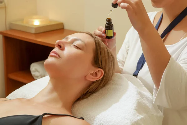 Face massage, a woman in the spa having anti-age face massage