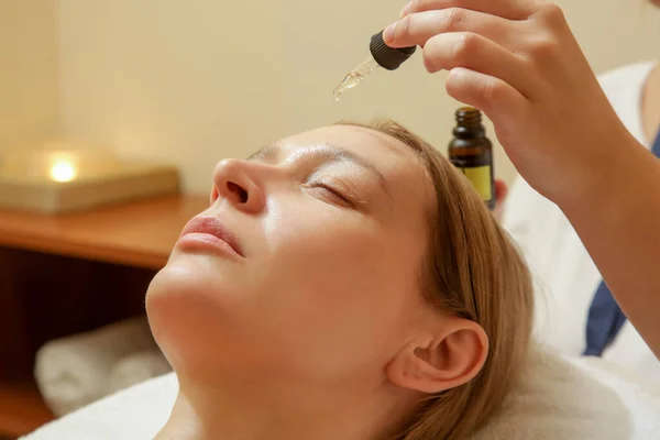 Face massage, a woman in the spa having anti-age face massage