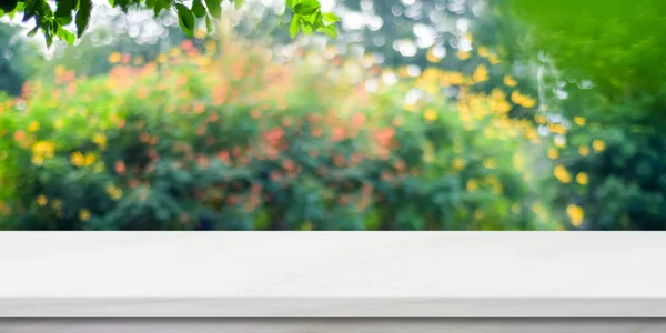 White marble table for food, product display over blur green garden background, Empty stone shelf, desk and blur tree park with bokeh light in spring, summer, Table top, counter and nature background