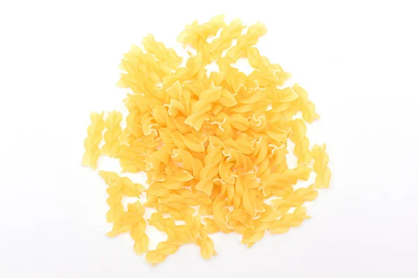 A Heap of Uncooked Fusilli Pasta Scattered on White Table — Stock Photo, Image