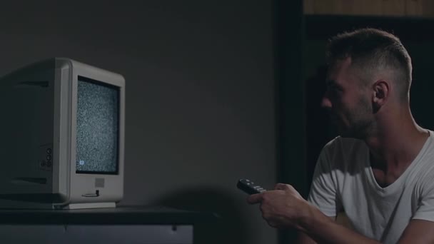 Controle Mental - Homem Zombificado em Branco T-shirt Switches Canais na TV — Vídeo de Stock