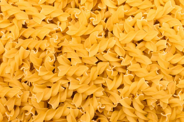 Tepelně neupravené těstoviny Fusilli - textura pozadí — Stock fotografie