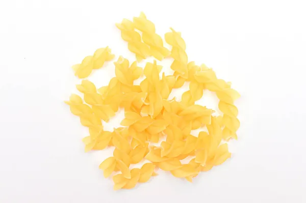 A Heap of Uncooked Fusilli Pasta Scattered on White Table — Stock Photo, Image
