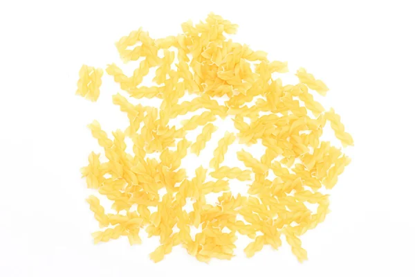 A Heap of Uncooked Fusilli Pasta Scattered on White Table — Stock Photo, Image