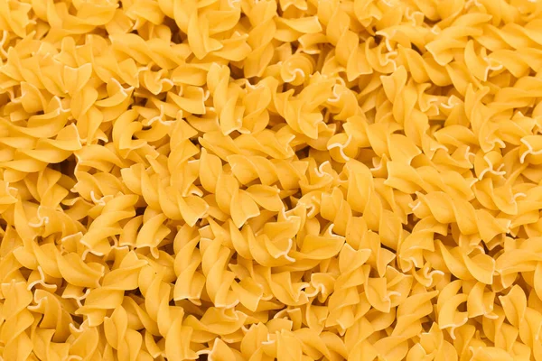 Főzetlen Fusilli tészta - textúra háttér — Stock Fotó