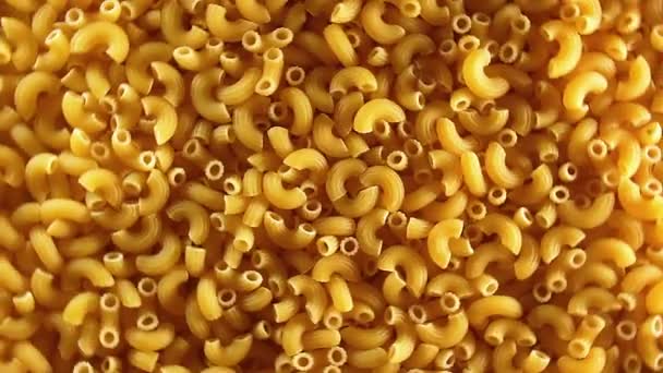 Uncooked Chifferi Rigati Pasta, Scattered Dry Macaroni - Rotating Background — Stock Video