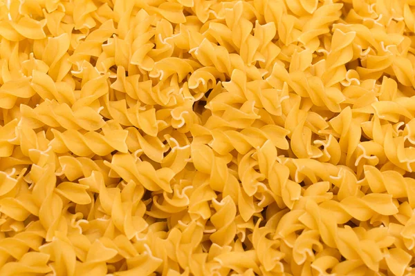 Főzetlen Fusilli tészta - textúra háttér — Stock Fotó