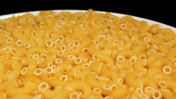 Uncooked Chifferi Rigati Pasta White Plate Rotating Black Background Fat — Wideo stockowe