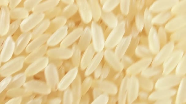 Dry Uncooked Parboiled Rice Background Rotating Clockwise Top View Close — 비디오