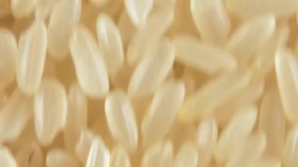 Dry Uncooked Parboiled Rice Background Moving Upward Top View Close — 비디오