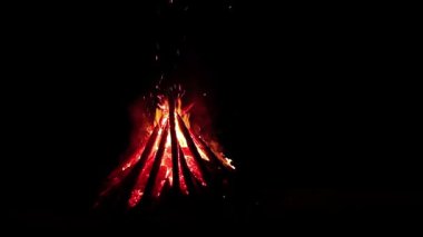 Burning Campfire - Isolated on Black. Wood on Fire. Flying Sparks. Travel and Tourism Concept. Big Flaming Bonfire at Summer Night - Static Shot, Timelapse