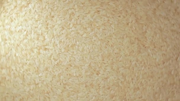 Dry Uncooked Parboiled Rice Background Rotating Right Top View Low — Vídeo de Stock