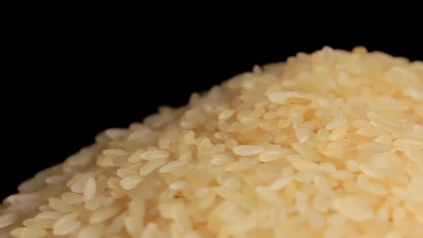 Dry Uncooked Parboiled Rice Heap Rotating Black Background Pile Raw — Stockvideo