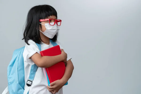 Happy Asian Little Preschool Girl Wearing Red Glasses Holding Books — стокове фото