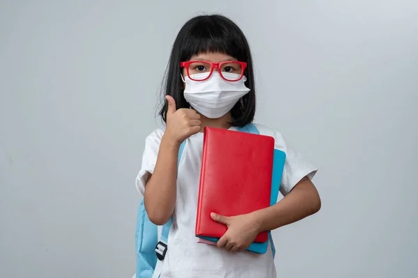 Happy Asian Little Preschool Girl Wearing Red Glasses Holding Books — стокове фото