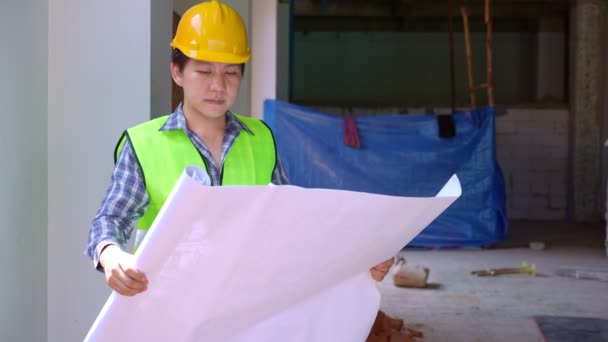 Asian Engineer Young Architect Put Helmet Safety Look Blueprint Inspect — Stockvideo