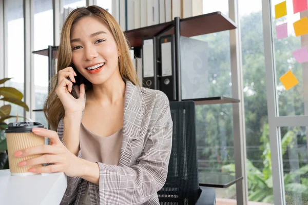 Happy young asian women startup entrepreneur talking whit partner or co-investor and smiling after success sign business contact, Happy girl on workplace. Distance learning online education and work.