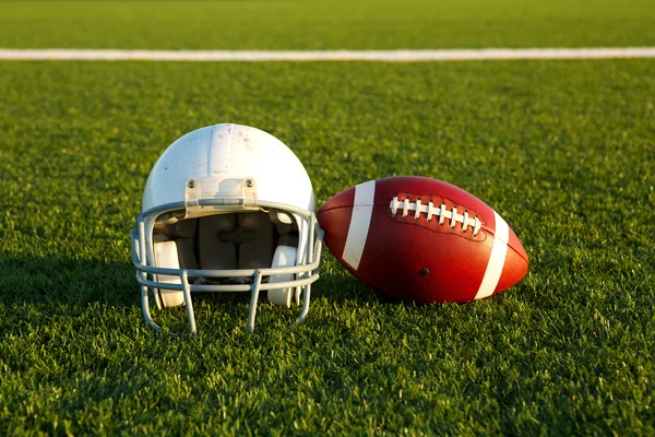 Football and Helmet on the Field — Stock Photo, Image