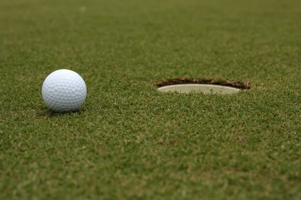 Boule de golf près de la coupe — Photo