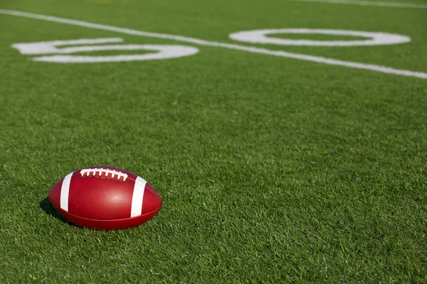 American Football on the Field near the Fifty — Stock Photo, Image