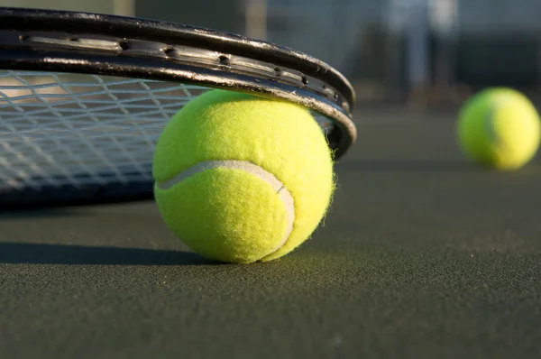 Pelotas de tenis y una raqueta — Stockfoto