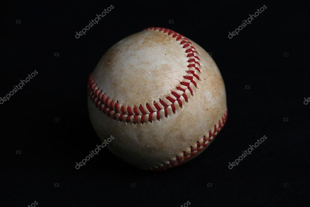Closeup view of worn baseball with no logos on black background