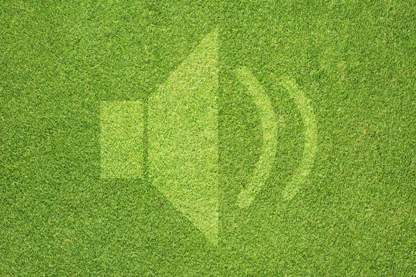Yeşil çim dokusu ve arka plan üzerinde hoparlör simgesi — Stok fotoğraf