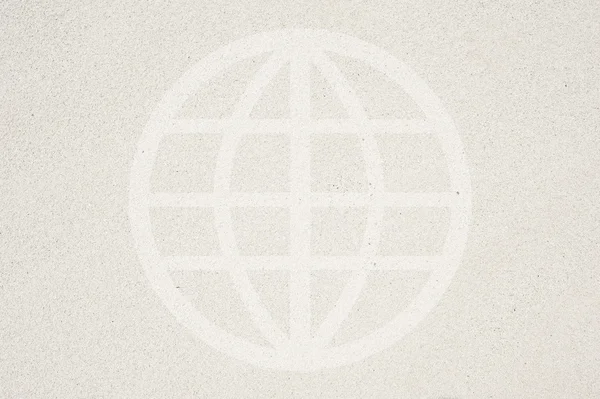 Global icon on sand background and textured — Stock Photo, Image