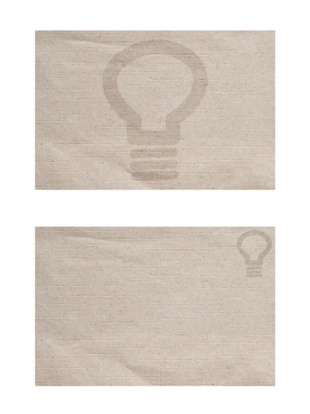 Icono de luz de bombilla sobre papel texturizado y fondo —  Fotos de Stock