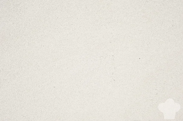 Koka ikonen på sand bakgrund och texturerat — Stockfoto