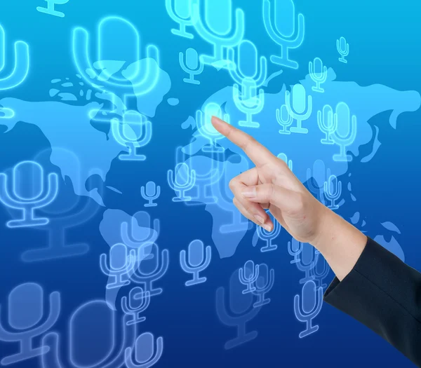 Hand pushing microphone button on a touch screen interface — Stock Photo, Image