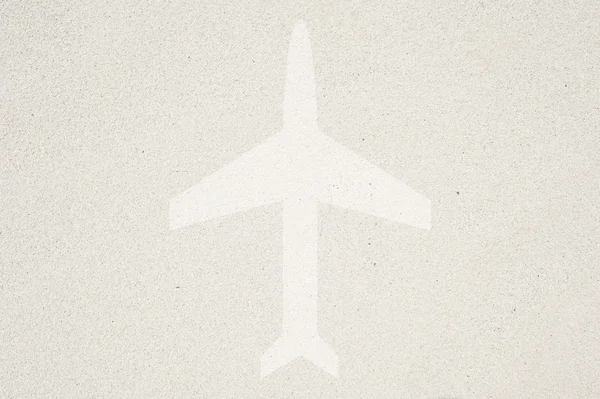 Εικονίδιο αεροπλάνο σε άμμο φόντο και υφή — Φωτογραφία Αρχείου